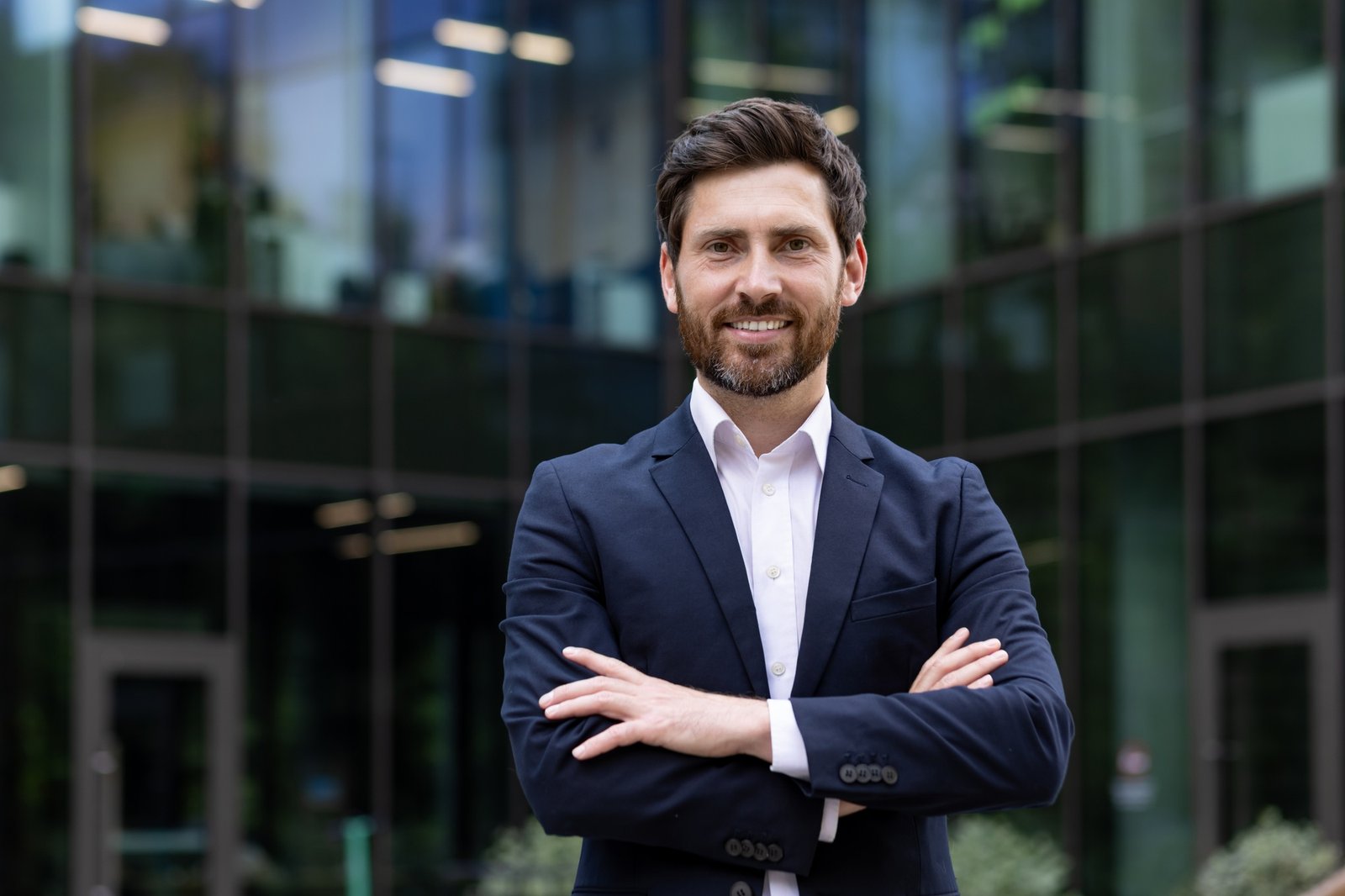 The portrait of a close successful young man of a businessman, the founder of a company in a suit
